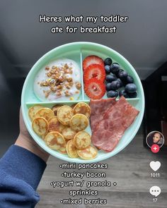 a person holding a plate with different foods on it and the words here what my todder ate for breakfast