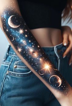 a woman's arm with stars and planets on it