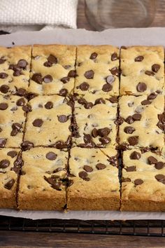 chocolate chip cookie bars sitting on top of a cooling rack