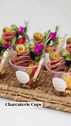 small cups filled with food sitting on top of a wicker tray