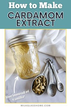 a jar filled with cardamom and spoons next to it