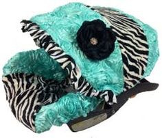 a zebra print hat with a flower on it