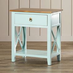 an end table with a wooden top and two drawers on the bottom, in front of a wall