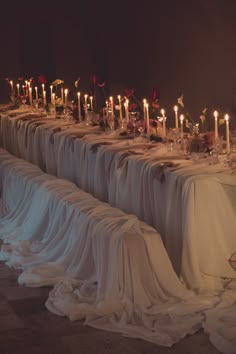 a long table with many candles on it