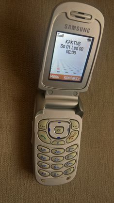 a cell phone sitting on top of a brown carpet