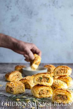 Chicken sausage rolls scattered on a table with a hand in the background dipping a sausage roll into sauce. Chicken Appetizers Easy, Gai Yang, Chicken Pies, Puff Pastry Chicken, Homemade Puff Pastry, Savoury Tarts