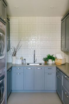 the kitchen is clean and ready to be used as a washer and dryer