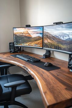 two computer monitors sitting on top of a wooden desk