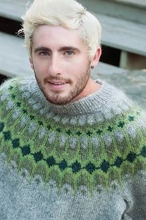 a man with blonde hair wearing a sweater