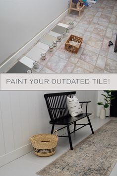 a room with white walls and tile flooring next to a black chair on the ground