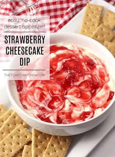 strawberry cheesecake dip in a white bowl with crackers on the side and text overlay