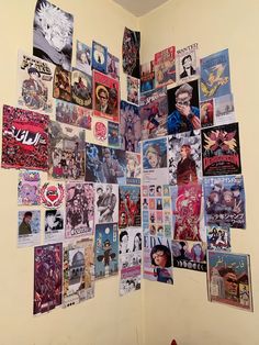 a wall covered in posters and stickers next to a fire hydrant on the floor