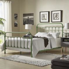 a green metal bed frame in a bedroom