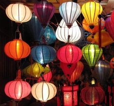 many colorful lanterns are hanging from the ceiling