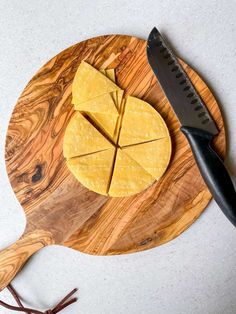 a cutting board with cheese and a knife on it