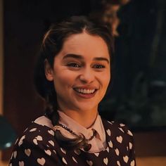 a woman sitting at a desk with her eyes closed