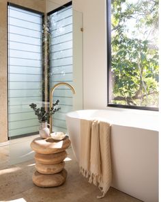 a white bath tub sitting next to a window