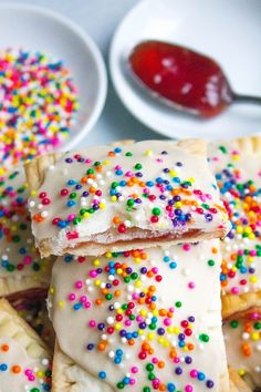 colorful sprinkles are on top of small pastries