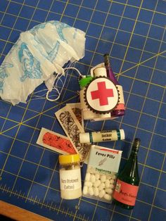 the contents of an emergency kit laid out on a cutting board with scissors and other items