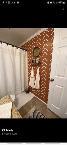 a bathroom with two towels hanging on the wall and a towel rack in front of the door