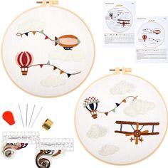 two cross stitch hoops with different types of embroidery on them, including an airplane and hot air balloon