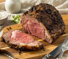 a large piece of meat sitting on top of a wooden cutting board