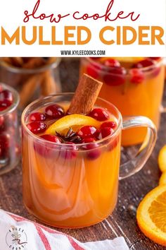 an orange and cranberry mulled cider is garnished with cinnamon