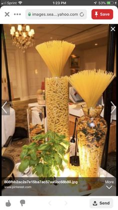 two vases filled with yellow flowers sitting on top of a white tablecloth covered table