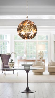 a living room filled with furniture and a chandelier hanging from it's ceiling