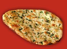 a piece of pizza with cheese and herbs on red background, close up view to the top