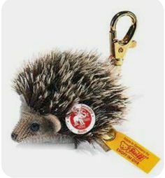 a small hedgehog keychain with a tag attached to it's side