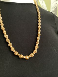 PLEASE NOTE: ALL SHIPPING INFORMATION MUST NOW INCLUDE A TELEPHONE NUMBER FOR ITEMS GOING TO THE USA.  This lovely 30" Vendome necklace is in very good vintage condition. As shown in the photo, the chain is tied rather than attached to the barrel clasp on one side. An easy fix. Otherwise, it's in beautiful condition.  It measures 30" long and could be doubled around smaller necks.  The ball beads are intricately pierced and are separated by smaller gold beads.  The chain that the beads are threa Festive 8mm Round Bead Necklace, Traditional Long Necklace With Beaded Chain And Round Beads, Festive Gold Long Necklace With Round Beads, Traditional Long Necklace With Round Beaded Chain, Gold Long Necklace With Round Beads For Festive Occasions, Traditional Long Necklace With Beaded Chain, Gold Beaded Necklaces For Jewelry Making (8mm Beads), Gold Necklaces With Large Oval Beads, Gold Beaded Chain Necklace With Oval Beads