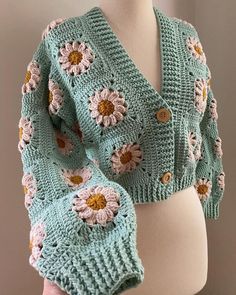 a crocheted shawl with flowers on it is shown in front of a mannequin's torso