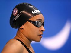 a woman wearing a swimming cap and goggles