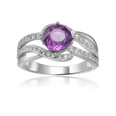 This luxurious ring is set in an ornately designed Sterling Silver band and features a round cut Natural Amethyst gemstone as the beautiful center stone. The band shimmers with encrusted White Sapphire in a flowing design that delicately wraps around the center stone. Metal - Sterling Silver Metal Weight - 3.60gm Main Stone - Amethyst Main Stone Shape - Round Main Stone Color - Purple Main Stone Weight - 0.70ct Accent Stone - White Sapphire Accent Stone Weight - 0.42ct Fine Color Jewels Dean Col Amethyst Wedding Ring, Amethyst Wedding Rings, Gemstone Solitaire Ring, White Sapphire Ring, Topaz Engagement Ring, Sapphire Stone, Rings For Her, Sterling Silver Bands, Amethyst Stone