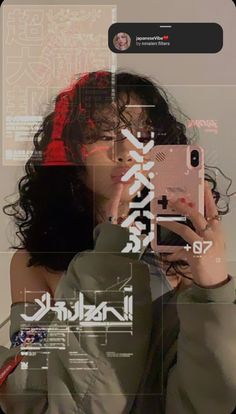 a woman taking a selfie with her cell phone in front of her face and japanese characters on the screen