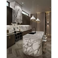 a large kitchen with marble counter tops and wooden flooring, along with two pendant lights hanging from the ceiling