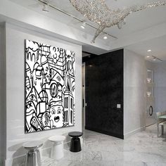 a white room with black and white artwork on the wall