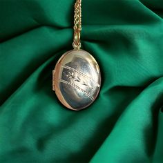 "Vintage engraved oval locket, on more modern 19.75\" inch gold plated chain. The locket is in 1.6\" inches long, including the bail. It is in good vintage condition, with signs of use.  Please contact me for combined shipping." Metal Oval Locket Necklace, Oval Metal Locket Necklace, Metal Oval Pendant Locket Necklace, Silver Oval Locket Necklace With Adjustable Chain, Oval Metal Locket Necklace Gift, Oval Metal Locket Necklace As Gift, Oval Metal Locket Necklace For Gifts, Antique Oval Personalized Locket Necklace, Oval Pendant Locket Necklace With Adjustable Chain For Keepsake