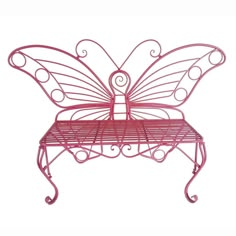 a pink metal bench with a butterfly design on it's back and wings attached to the seat