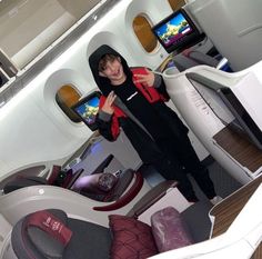 a woman standing in the aisle of an airplane