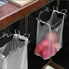 two plastic bags are hanging on the wall next to each other in front of a sink