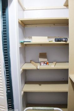 an empty closet with shelves and tools in it