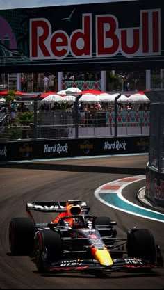 a red bull racing car driving down a race track