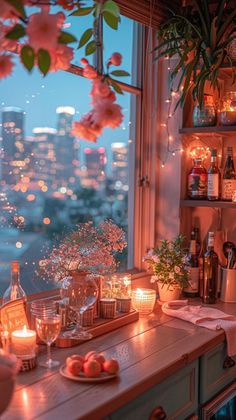 a kitchen counter topped with lots of food and drinks next to a window covered in pink flowers