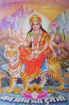 the hindu goddess sitting on top of a tiger