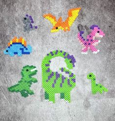 some pixelated animals are sitting on the ground next to each other and one is painted with different colors