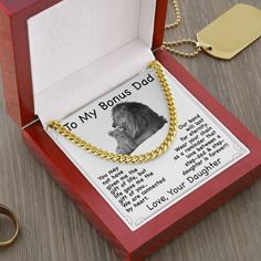 a box with a dog's name and a gold chain attached to it