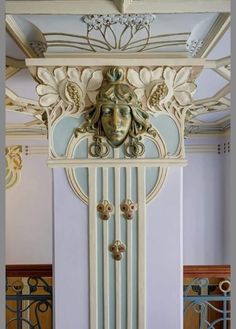 an ornate white and gold clock with a face on it