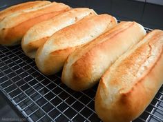 six loaves of bread sitting on top of a cooling rack